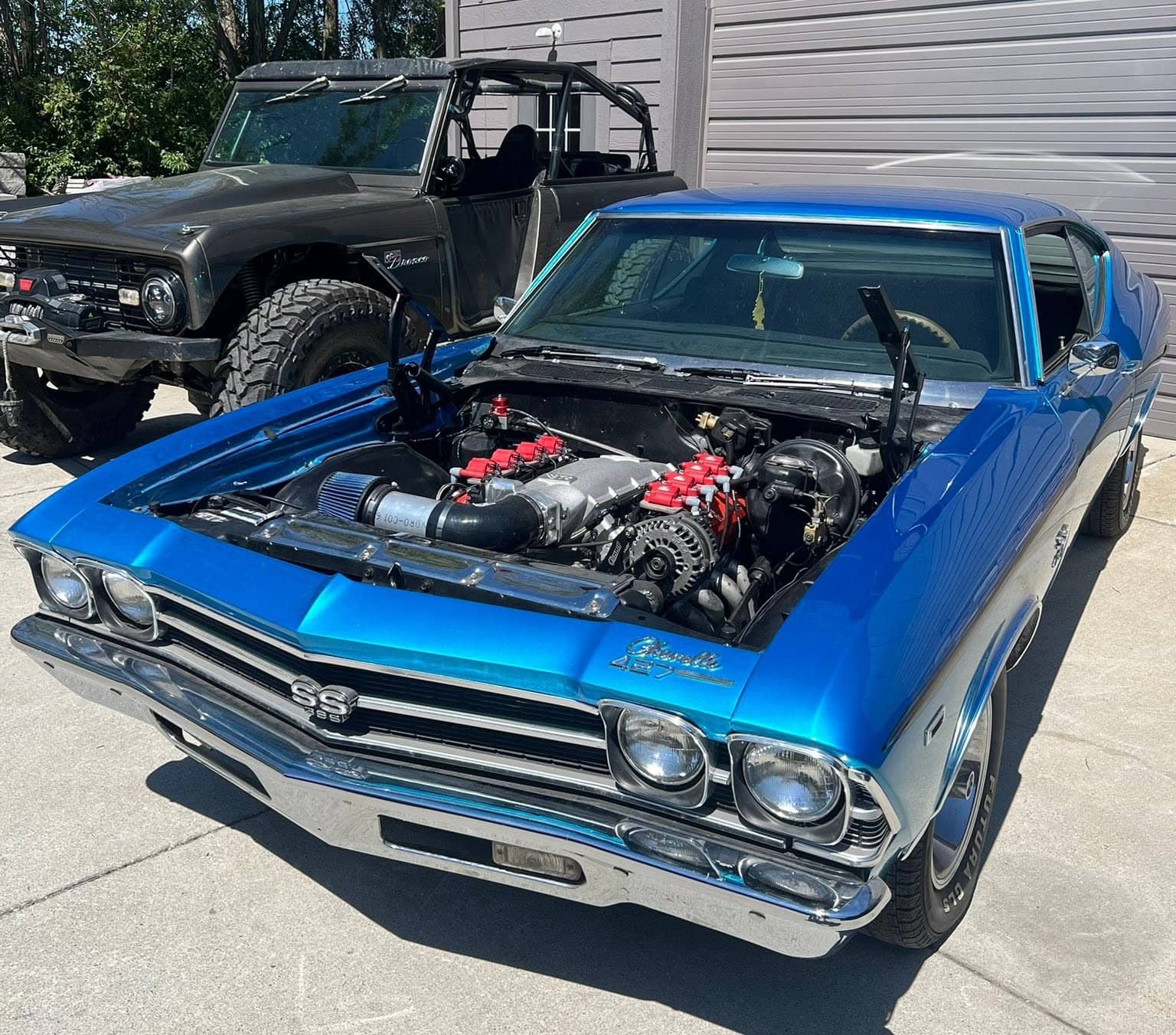 Blue Chevrolet Chevelle SS 396 with the hood removed to display its modified engine bay.